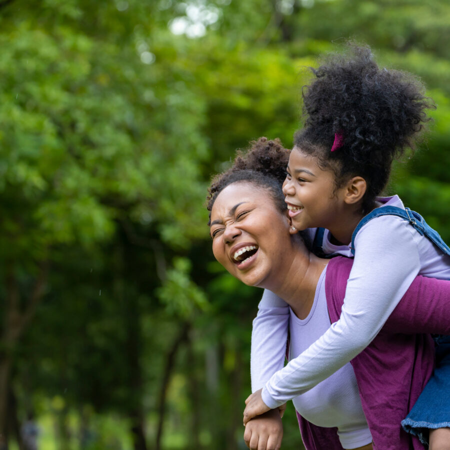 Mother and daugther playing piggyback riding