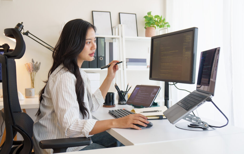 Woman looking at a desk working on a computer