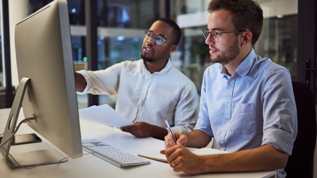 Two-men-in-shirts-look-at-computer-screen